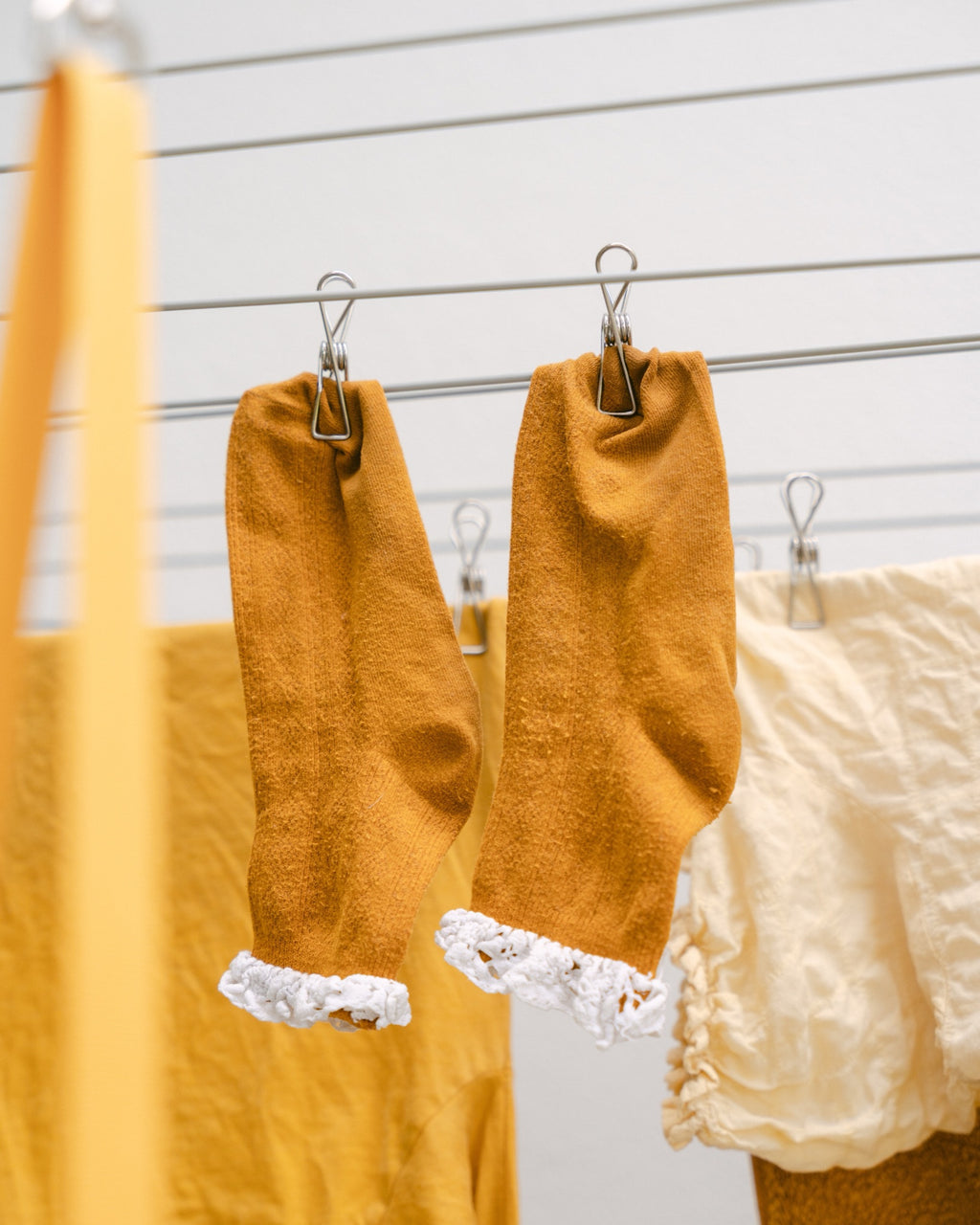 Mustard socks held on the line with Forever Pegs