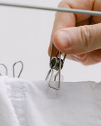 Close-up of a Forever Pegs stainless steel peg and its strong spring holding a sheet
