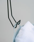 Close-up of the powder-coated Hang Easy Basket Hanger hook gripping a basket handle