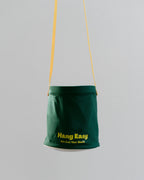 Green Hang Easy Peg Bag hanging from a clothesline by its yellow strap