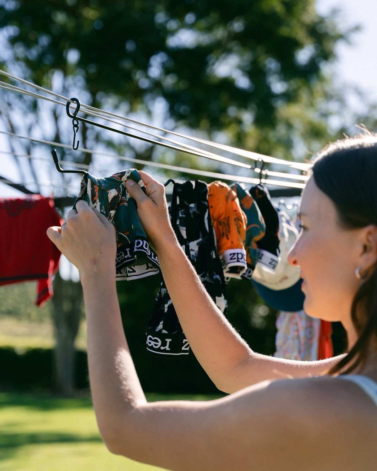 Filling The Undie Hanger with undies on a sunny rotary clothesline – no pegs needed